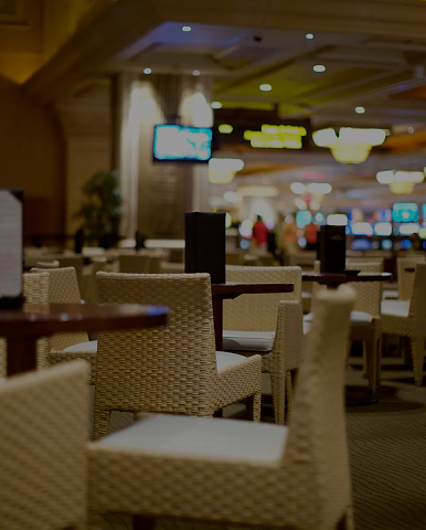 Empty wicker chairs in dim casino lounge