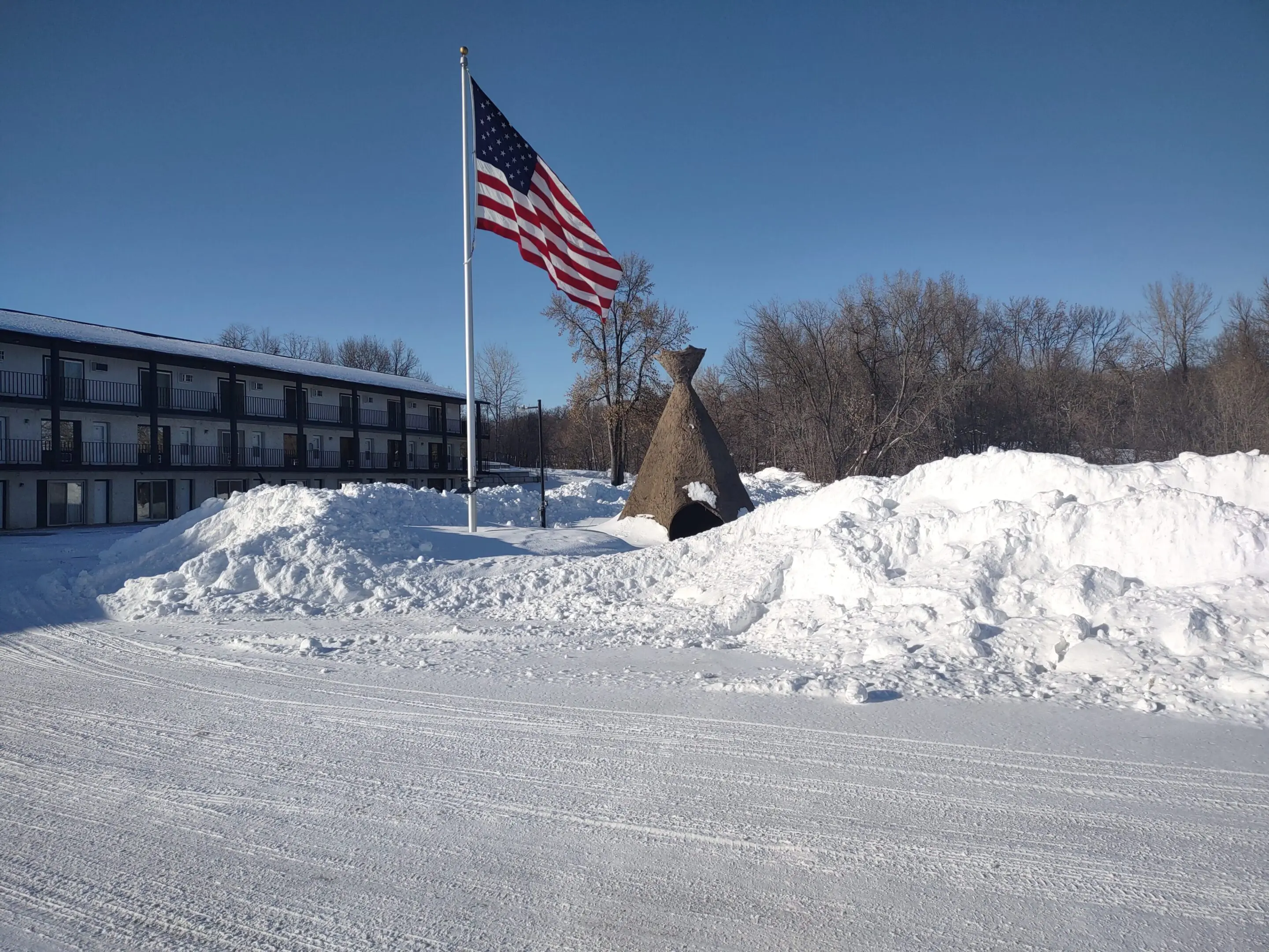 American flag and monument in snowy landscape