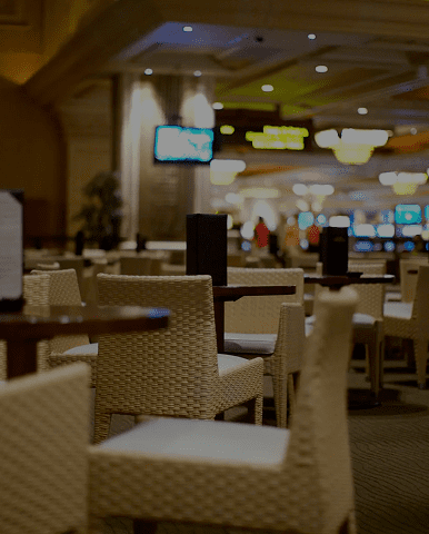 Empty wicker chairs in dim casino lounge